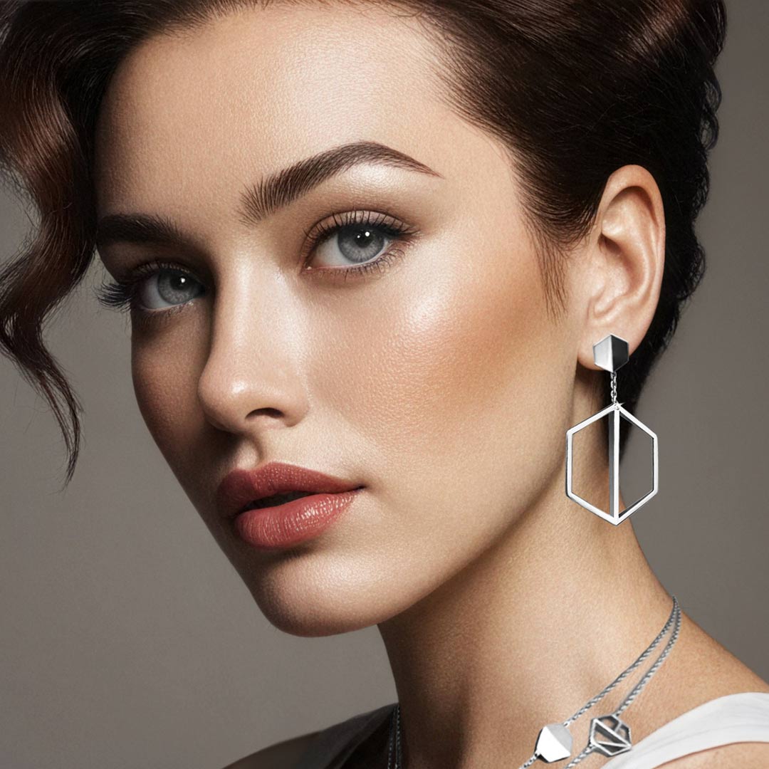 Naude Bourn's Illuminate You dangle earrings in white gold, offering a sleek and modern design that enhances sophistication and style.