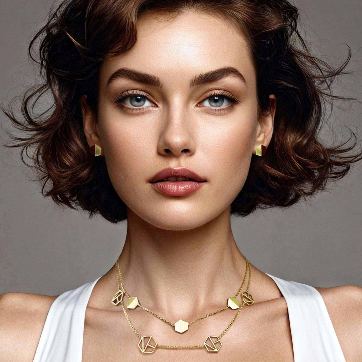 Naude Bourn's Know You stud earrings and Embrace You layered choker necklace in 18k yellow gold, showcasing unique jewelry design and craftsmanship.