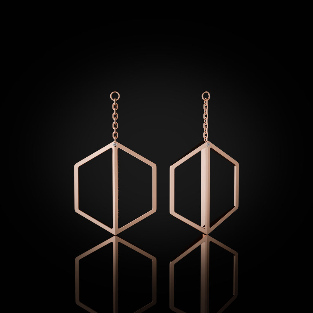 Naude Bourn's Illuminate You dangle earrings in rose gold, showcasing a stunning design that enhances any look with a touch of elegance and sophistication.