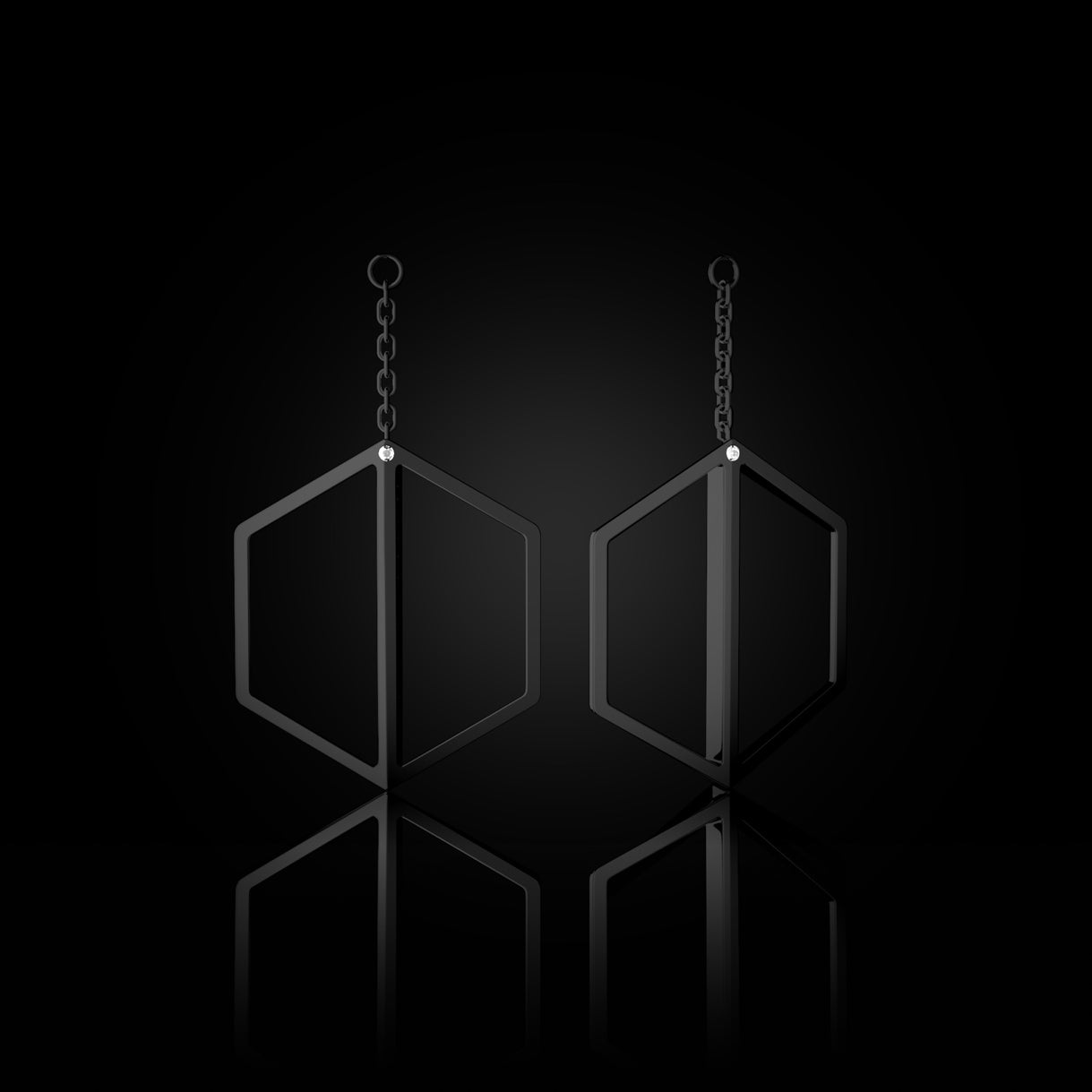 Illuminate You Dangles in Stealth Black Gold – short earring accessory with cascading hexagons, handcrafted by Naude Bourn. Sustainable gold jewelry, ethical jewelry, handcrafted artisan jewelry, fine jewelry, high-end jewelry, and ethical luxury. A sculptural design from sustainable jewelry brands and a unique jewelry gift in black gold.